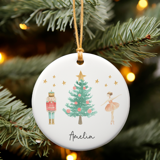 Ceramic ornament with Nutcracker and Sugar Plum Fairy illustration. Personalised with name in black script font.