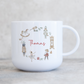 White polymer childs mug with traditional christmas illustration wreath. Personalised with name in red script font.