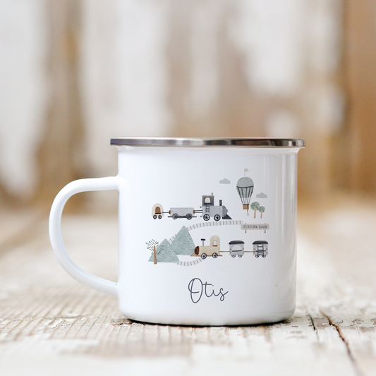 White mug with train design and 'Otis' branding on a wooden surface