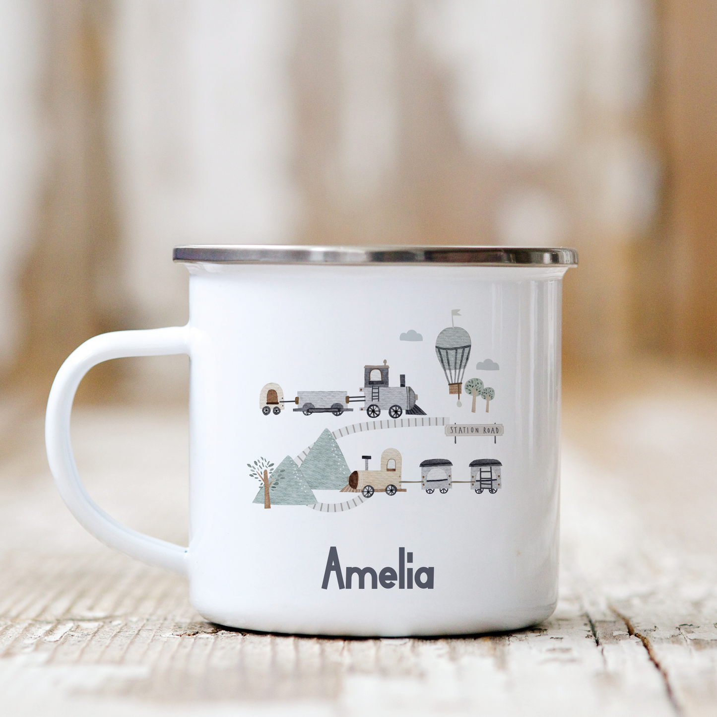 White mug with illustrations and the name 'Amelia' on a wooden surface