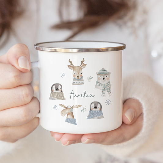 Person holding a mug with illustrations of animals wearing hats and the name 'Aurilia'.